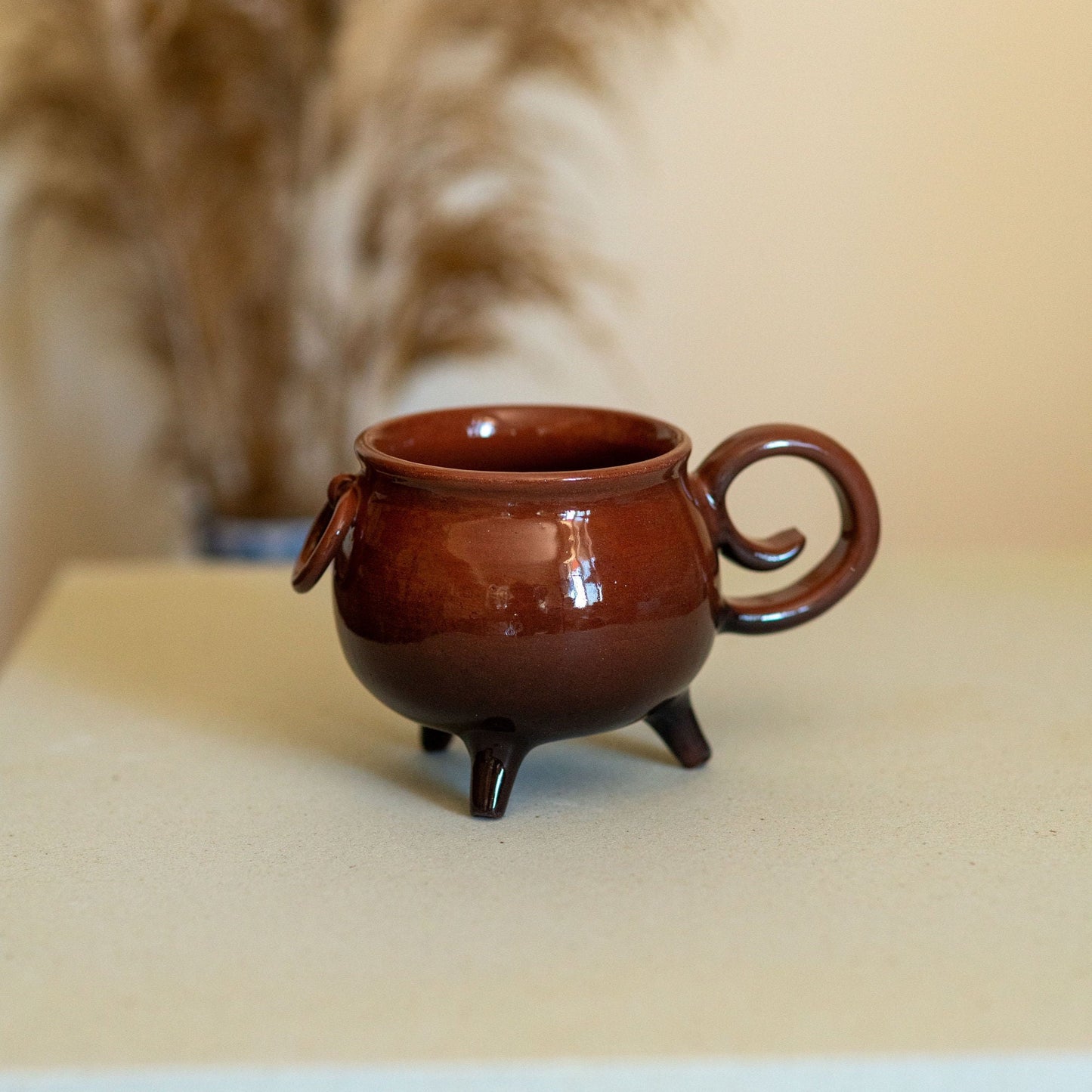 Ceramic Halloween mug designed like a witch's cauldron. This handcrafted pottery mug is perfect for autumn festivities, adding a spooky touch to your drinkware collection. Ideal for coffee, tea, or hot cocoa, and makes a unique Halloween gift.