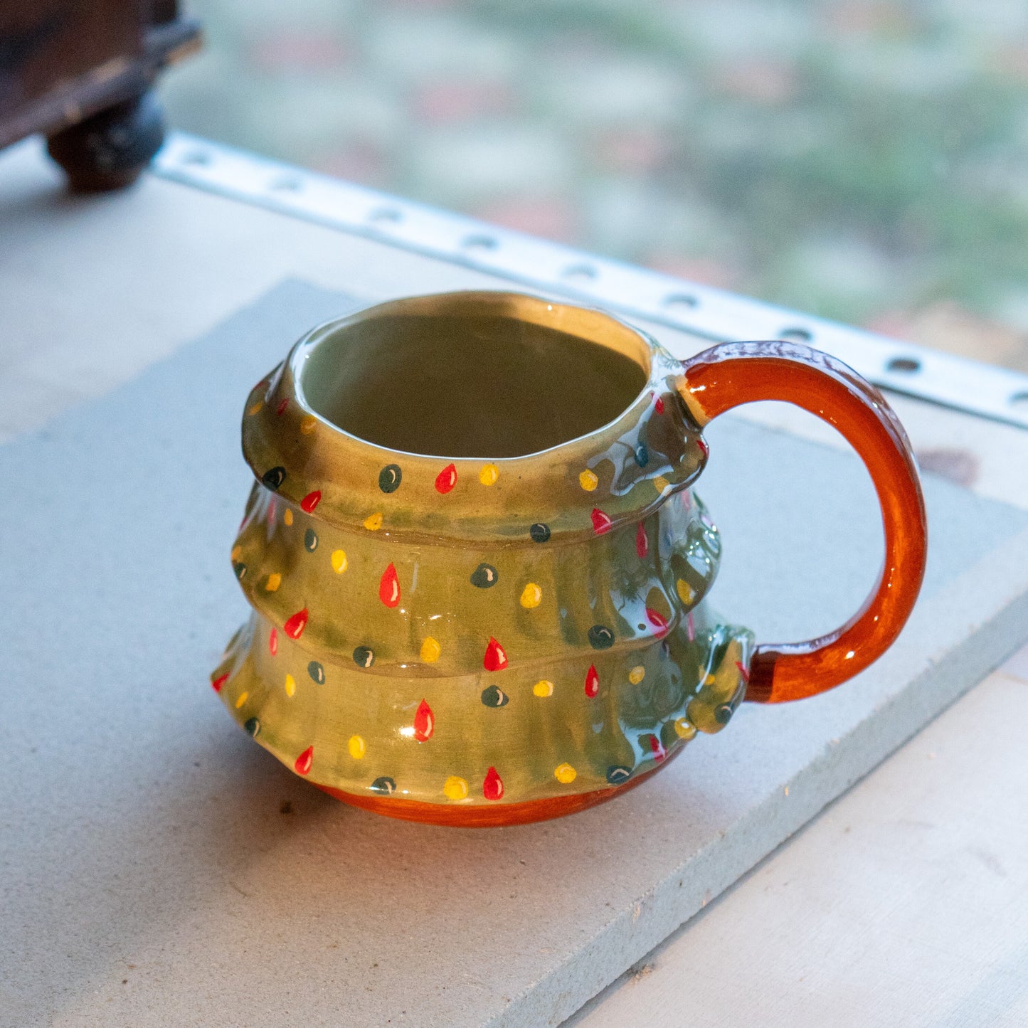 Side view of the Pine Tree Mug, emphasizing the craftsmanship of the handmade pottery and its unique design