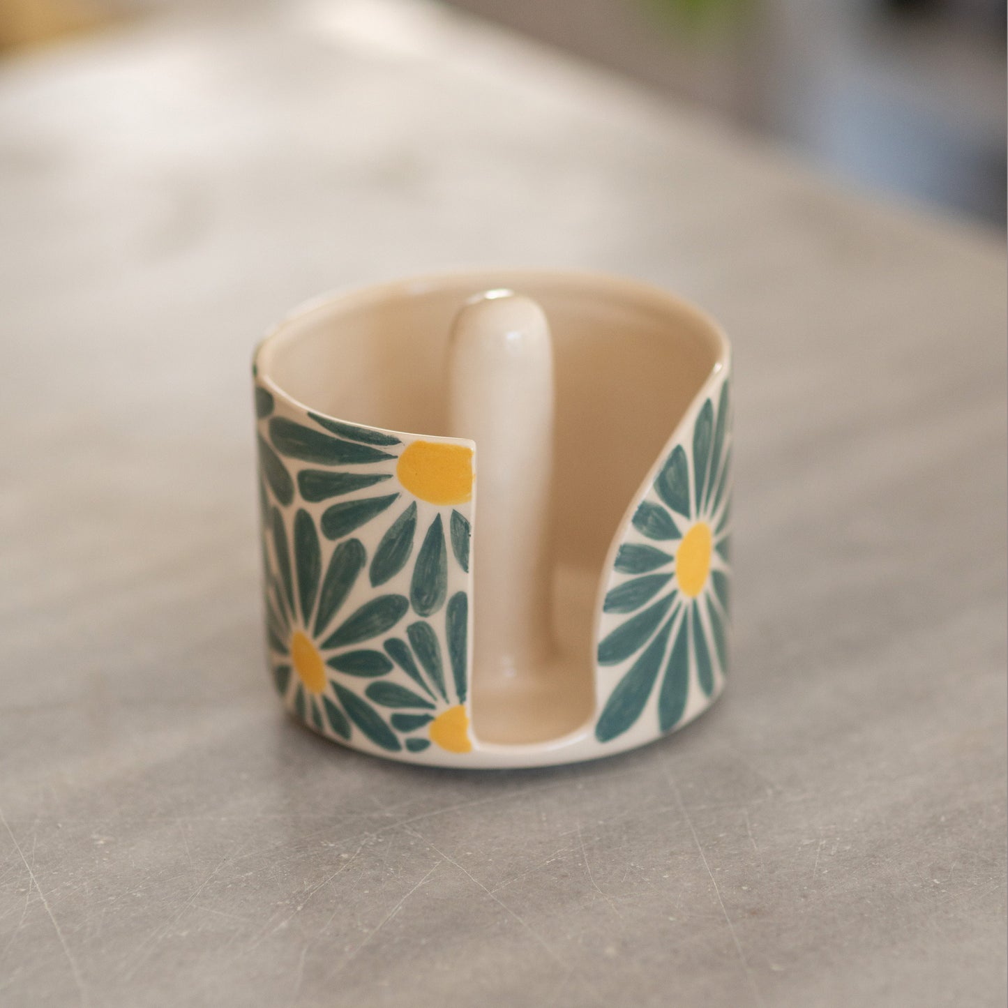 Artisan ceramic paper towel holder featuring detailed floral patterns. Handmade and durable, this piece is ideal for everyday use or special occasions. It adds a touch of elegance and functionality to your kitchen, making it a perfect decor item.