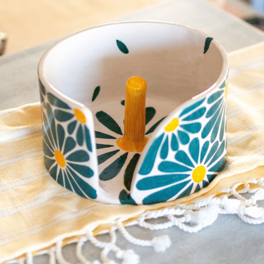 Handcrafted turquoise daisy-decorated paper towel holder, showcasing intricate detailing and vibrant colors